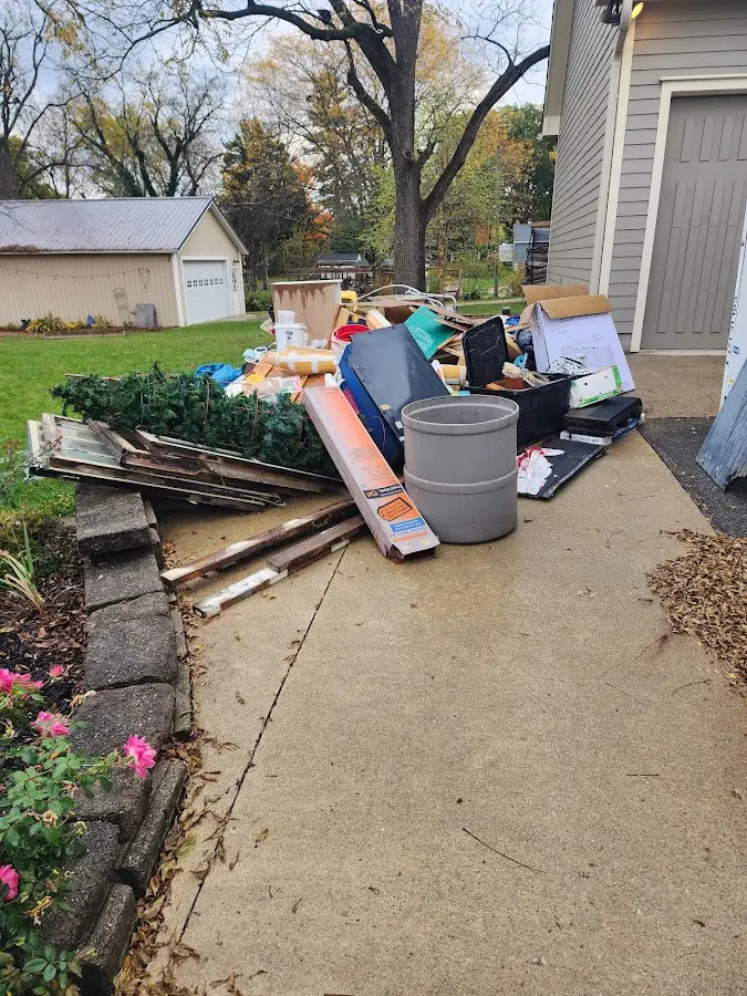 Dumpster being loaded with debris for Estate Cleanout Dumpster Rental in Golden Gate